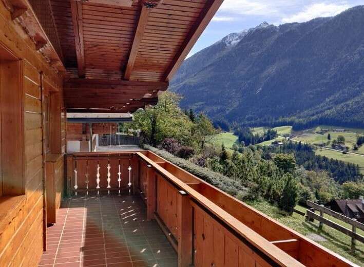 Enjoy breathtaking mountain views from this charming balcony.