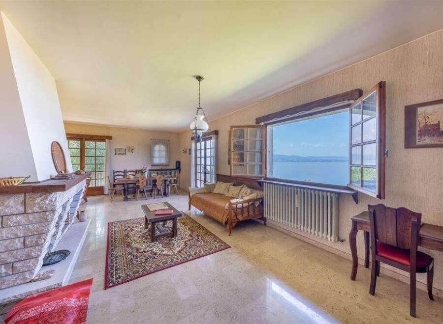 Lakefront living room with stunning views and a cozy fireplace.