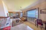 Lakefront living room with stunning views and a cozy fireplace.