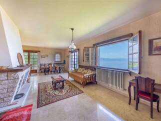 Lakefront living room with stunning views and a cozy fireplace.