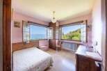 This charming bedroom boasts stunning lake views through its large windows, creating a serene and relaxing atmosphere.
