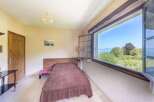 This charming bedroom boasts a tranquil atmosphere with its rustic wooden bed and stunning lake views.