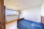 This charming bedroom boasts stunning lake views from its large window, creating a serene and relaxing atmosphere.