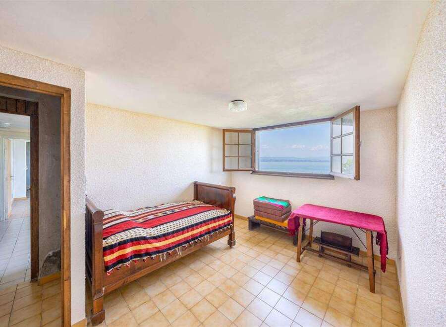This charming bedroom boasts stunning lake views through its large window.