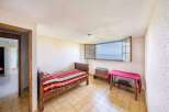 This charming bedroom boasts stunning lake views through its large window.