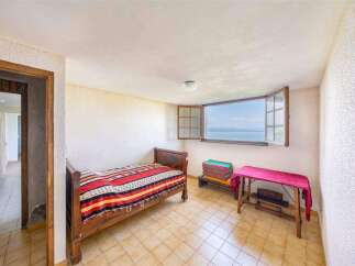 This charming bedroom boasts stunning lake views through its large window.