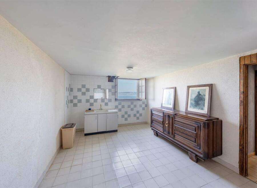 This stunning property boasts a spacious, bright interior with tiled floors and large windows offering breathtaking views.