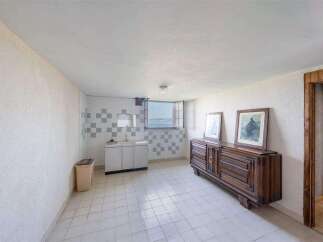 This stunning property boasts a spacious, bright interior with tiled floors and large windows offering breathtaking views.