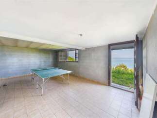 This property boasts a spacious basement game room, perfect for recreation and leisure.