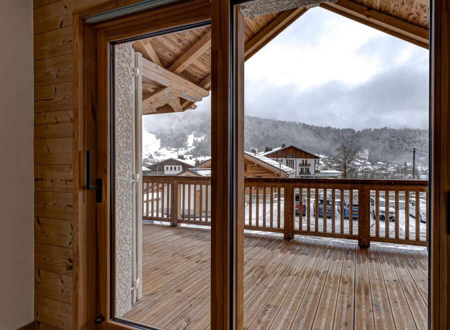 Step into a world of alpine charm with this stunning property, offering breathtaking views of snow-capped mountains.