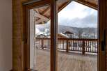 Step into a world of alpine charm with this stunning property, offering breathtaking views of snow-capped mountains.