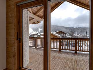 Step into a world of alpine charm with this stunning property, offering breathtaking views of snow-capped mountains.