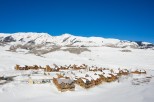 Luxury mountain homes nestled in a snowy landscape, offering breathtaking views and serene surroundings.