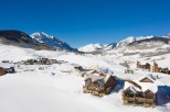 Luxury mountaintop homes nestled in a stunning winter landscape.