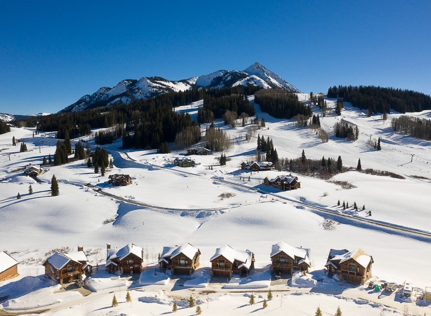 Luxury ski-in/ski-out homes nestled in the snowy mountains.
