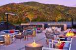 This rooftop lounge boasts stunning mountain views, cozy seating areas with fire pits and heaters, and a stylish dining space perfect for evening gatherings.