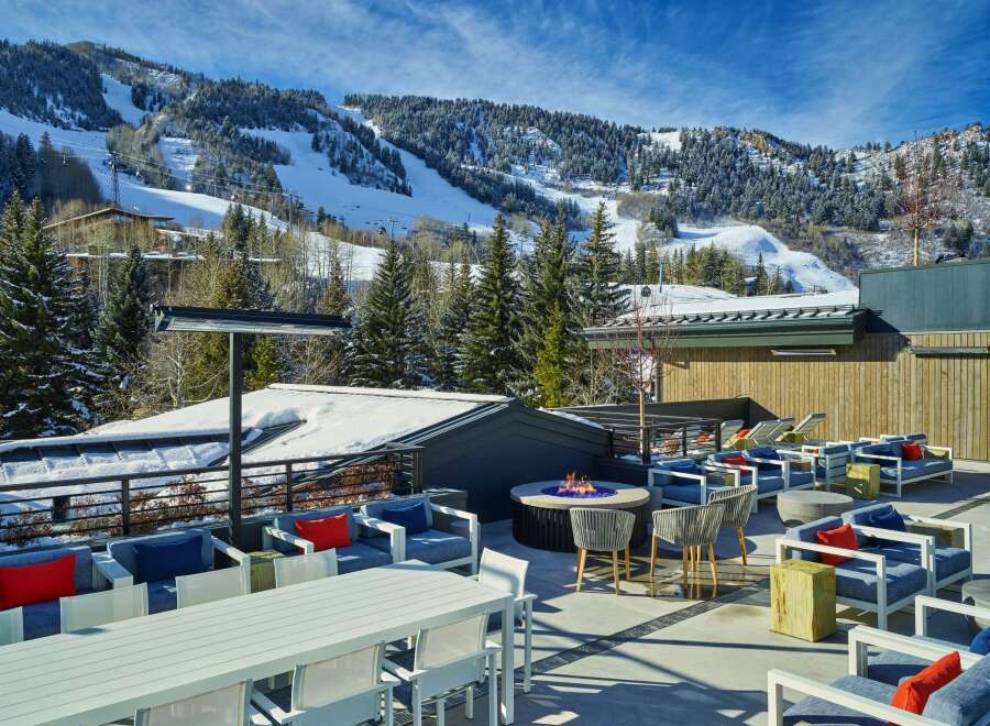 This stunning rooftop lounge boasts breathtaking views of snow-capped mountains and ski slopes, creating a luxurious and relaxing atmosphere.