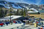 This stunning rooftop lounge boasts breathtaking views of snow-capped mountains and ski slopes, creating a luxurious and relaxing atmosphere.
