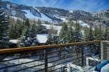 This luxurious property boasts breathtaking views of snow-capped mountains and a ski resort, all visible from a private balcony.