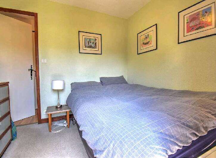 Cozy bedroom with double bed and light blue bedding.