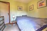 Cozy bedroom with double bed and light blue bedding.
