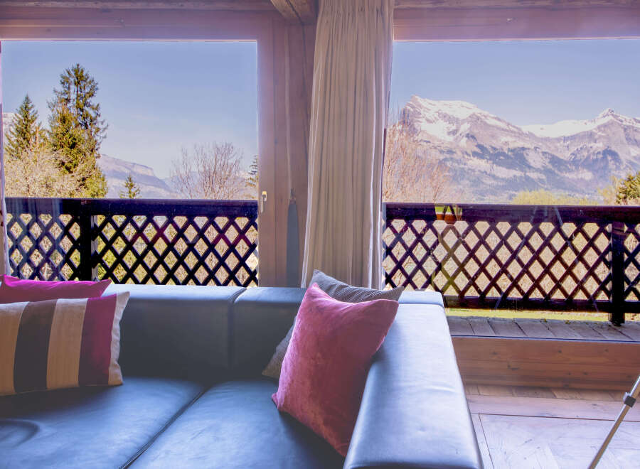 Mountain view living room with comfy couch and pillows.