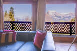 Mountain view living room with comfy couch and pillows.