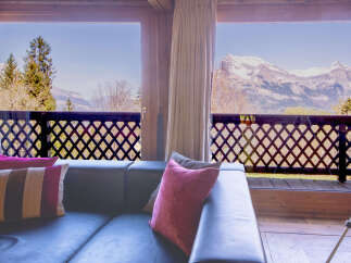 Mountain view living room with comfy couch and pillows.
