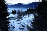 Secluded mountain chalet nestled in a snowy landscape, offering breathtaking views.