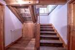 This charming property boasts a rustic wooden staircase, adding character and warmth to the home.