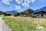 Discover this idyllic building plot nestled in the heart of the Alps, offering breathtaking mountain views.
