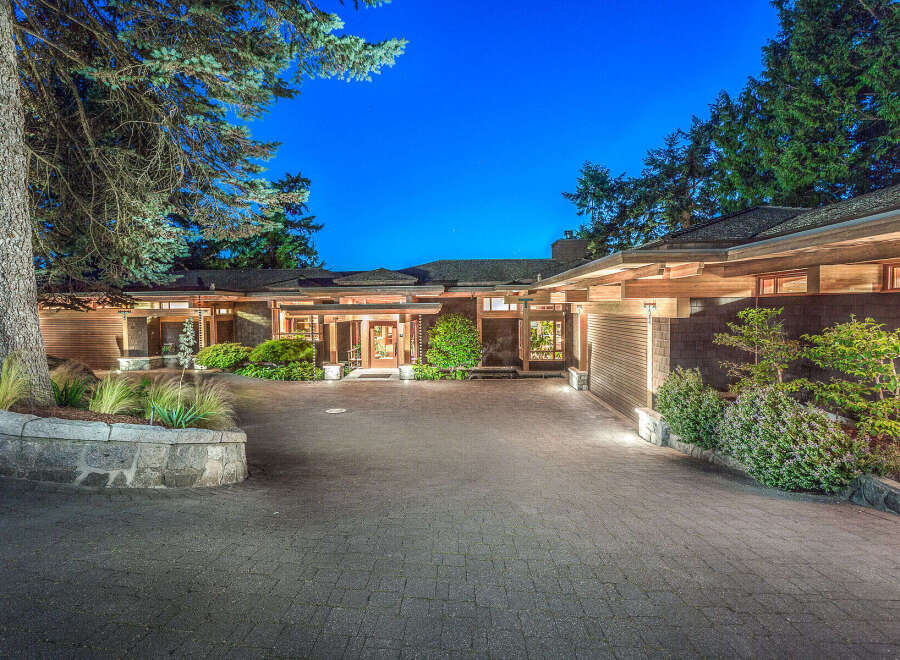 This stunning property boasts a spacious driveway, beautifully landscaped grounds, and an inviting entrance.