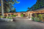 This stunning property boasts a spacious driveway, beautifully landscaped grounds, and an inviting entrance.