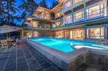 This luxurious waterfront home boasts a stunning outdoor oasis, complete with a large, inviting pool and spa.