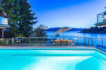 Luxury waterfront property boasts stunning sunset views and a private infinity pool.