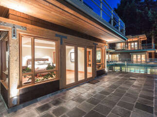 This stunning property boasts a luxurious master bedroom with large windows offering breathtaking views, a spacious patio perfect for outdoor entertaining, and a modern design that seamlessly blends indoor and outdoor living.