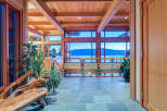 This stunning home boasts a spacious open-concept design with expansive windows offering breathtaking views of the water and mountains.