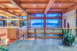 This stunning home boasts a breathtaking view of the water and mountains, visible through expansive windows.