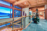 This stunning home boasts a spacious open floor plan with walls of windows offering breathtaking water views.