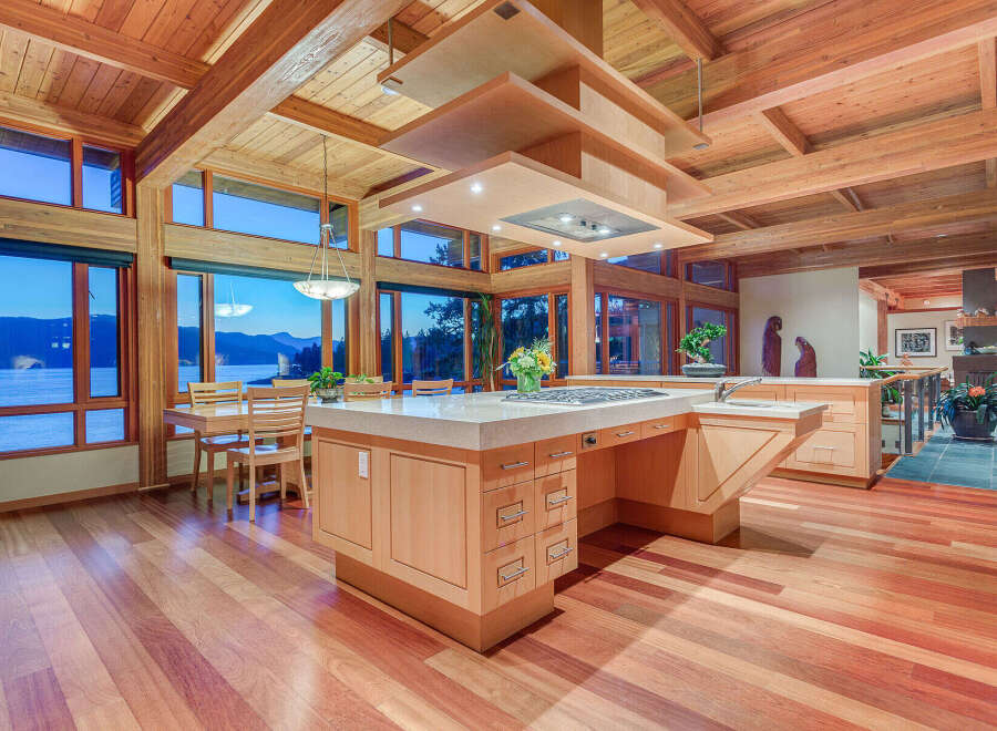 This stunning kitchen boasts a large island with built-in seating, high-end appliances, and ample storage.