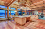 This stunning kitchen boasts a large island with built-in seating, high-end appliances, and ample storage.