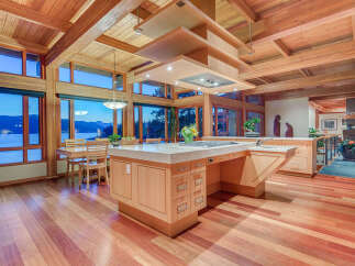 This stunning kitchen boasts a large island with built-in seating, high-end appliances, and ample storage.