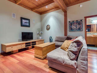 This cozy family room boasts a built-in entertainment center, hardwood floors, and a comfortable sectional sofa perfect for movie nights.