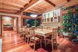 This stunning dining room boasts a large, light-wood table surrounded by comfortable chairs, perfect for family gatherings.
