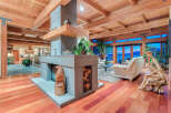 This stunning home boasts a spacious open floor plan with hardwood floors, high ceilings, and large windows offering breathtaking views.
