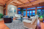 This stunning waterfront property boasts a spacious living area with floor-to-ceiling windows offering breathtaking views.