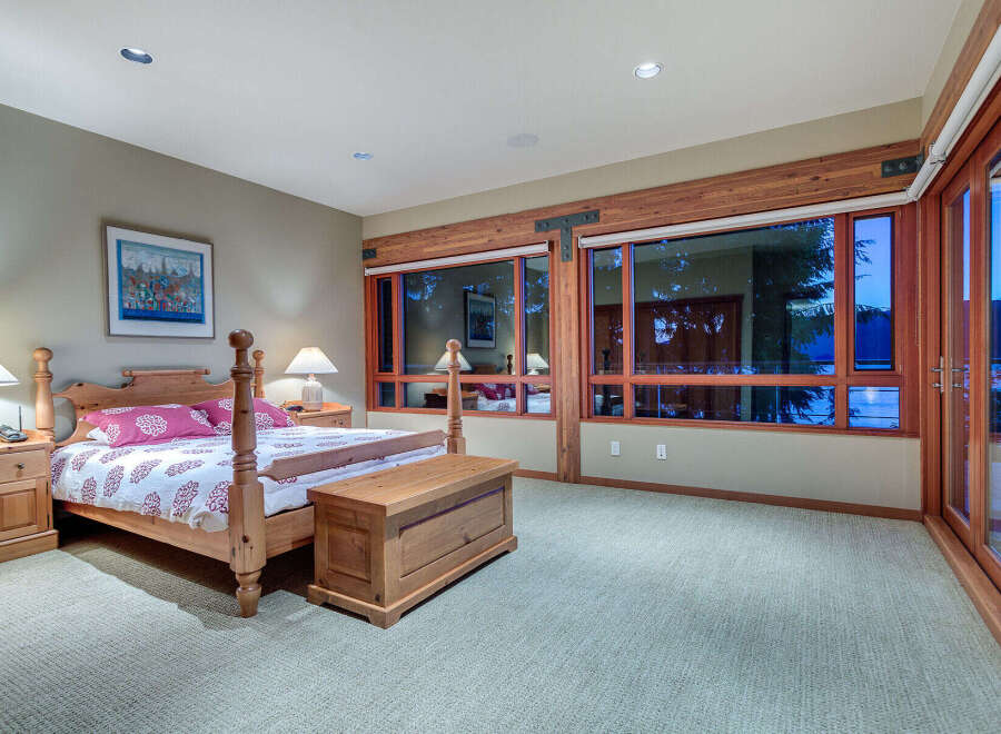 This luxurious bedroom boasts a king-size bed with a stunning view of the water.