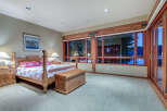 This luxurious bedroom boasts a king-size bed with a stunning view of the water.