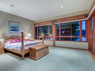 This luxurious bedroom boasts a king-size bed with a stunning view of the water.