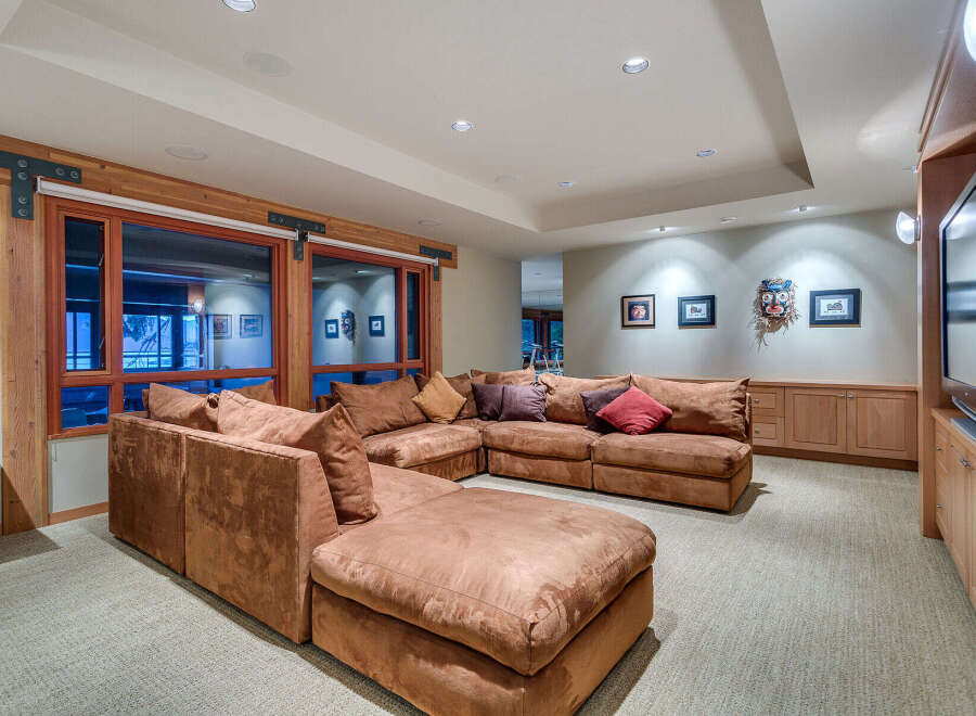 This luxurious family room boasts a spacious sectional sofa, perfect for movie nights and family gatherings.